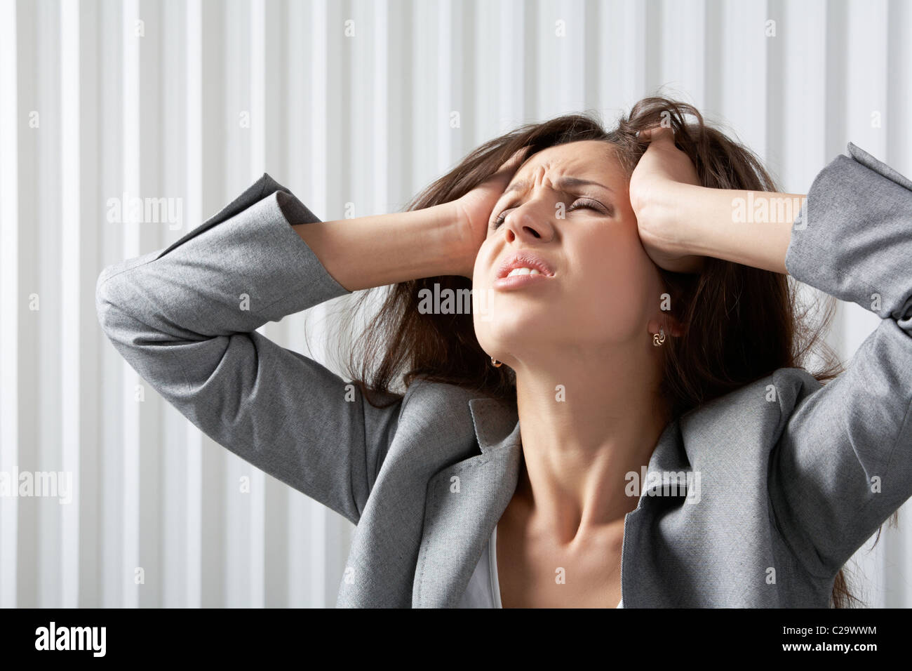 Eine frustrierte Geschäftsfrau disarranging ihr Haar Stockfoto