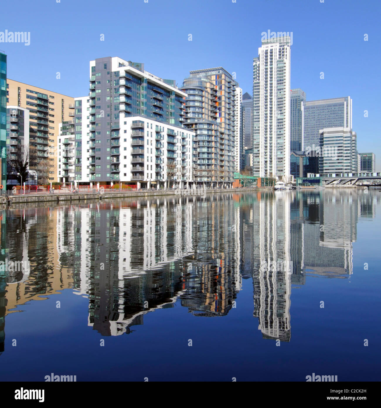 Reflexion über Wasser der städtischen Wohnung Wohnung Gehäuse in real Immobilienentwicklung in der Regeneration von Inner Millwall Dock Isle of Dogs East London Großbritannien Stockfoto