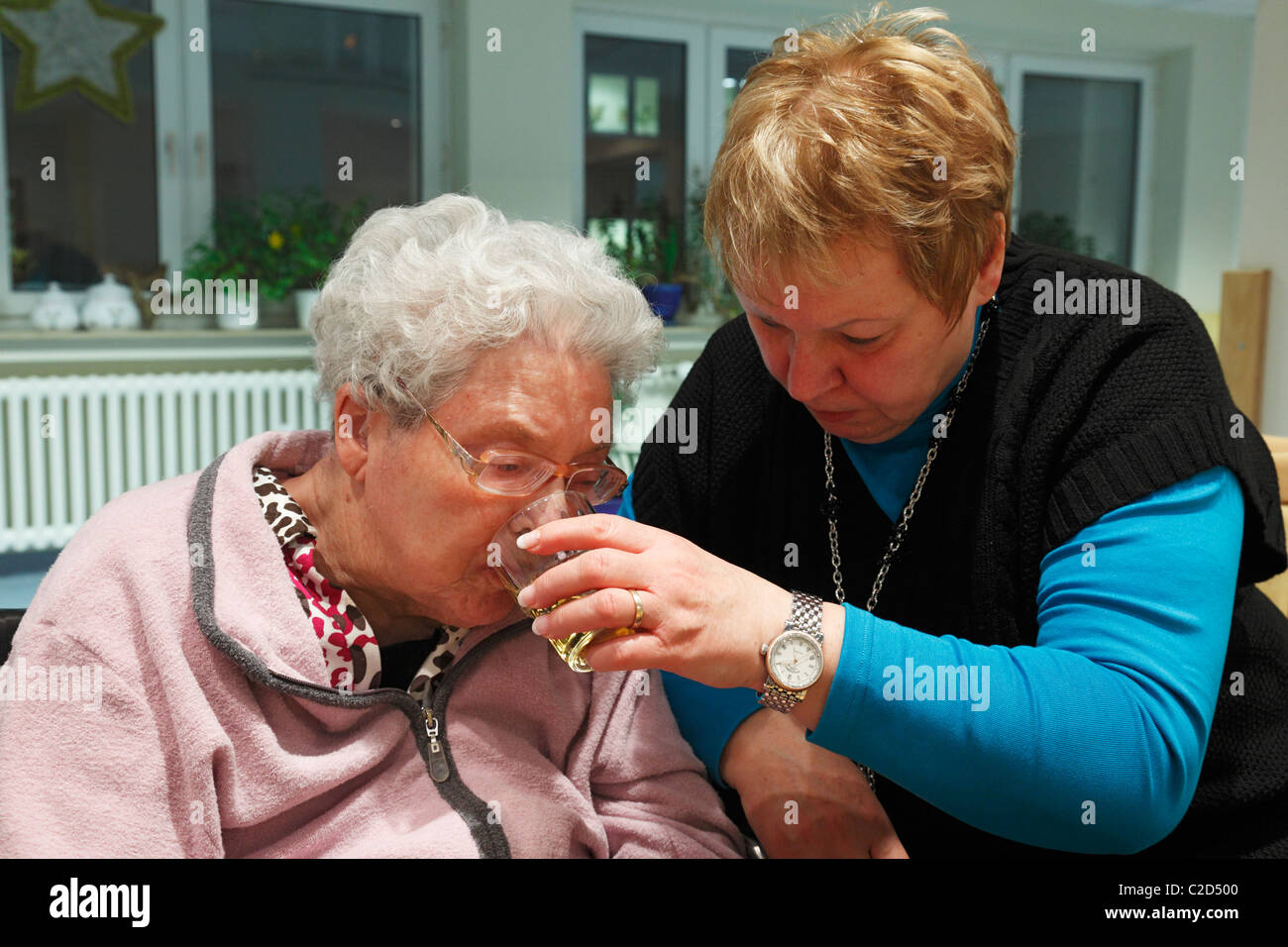 Menschen, körperlicher oder geistiger Behinderung, Alter, Altersheim, Altenzentrum der St. Clemens-Hospitale in Sterkrade, ältere Frau, im Alter von 70 bis 85 Jahre, Demenz-Erkrankung, eine Krankenschwester hilft ihr zu trinken, im Alter von 50 bis 60 Jahre, Waltraut, Elke, D-Oberhausen, Ruhrgebiet, niedriger R Stockfoto