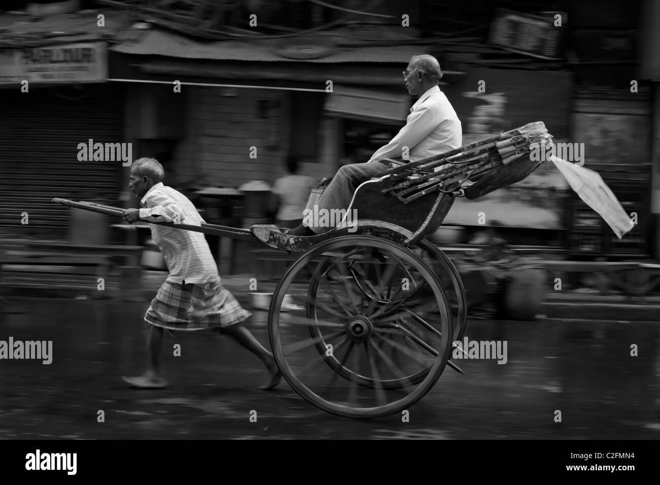 Mann zog Rikscha mit Passagier, Kolkata, West Bengal, Indien Stockfoto