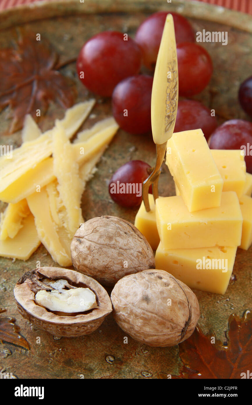 Käseplatte mit Trauben und Nüssen Stockfoto