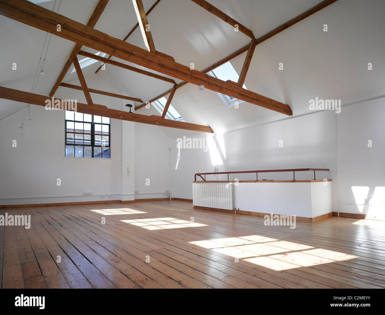 Leere Büroräume mit freiliegenden Holzbalken und Velux-Fenster Stockfoto