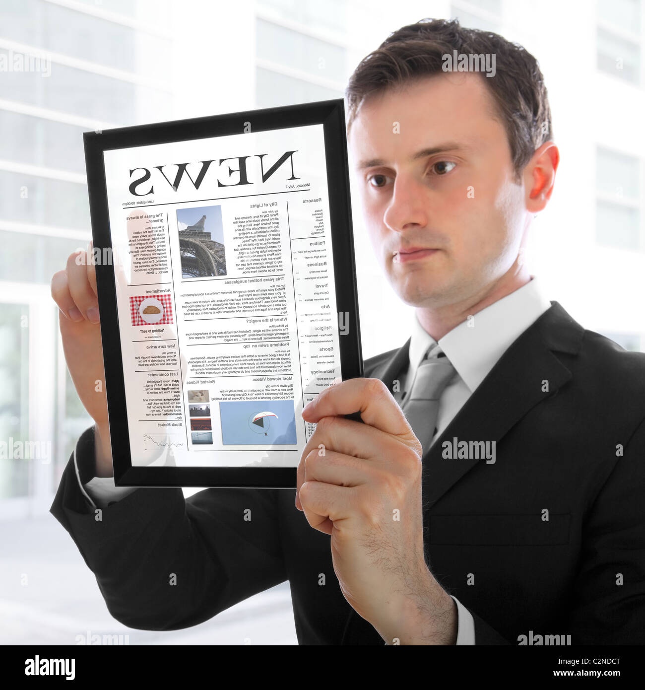 Geschäftsmann hält einen Touchpad-pc und eine Zeitung lesen Stockfoto