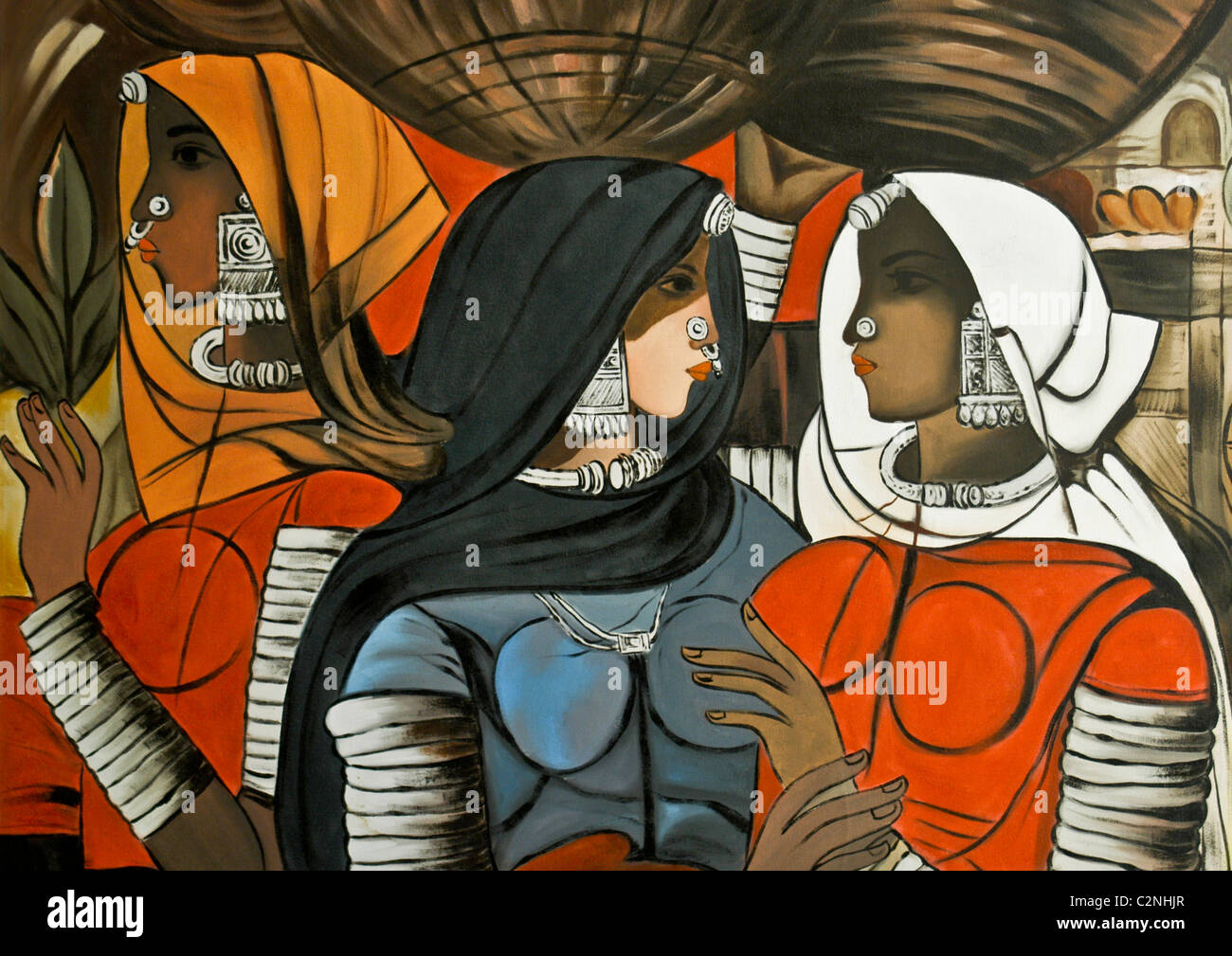 Bild kultureller Repräsentation von drei Frauen aus Rajasthan Indien in Trachten und Schmuck tragen Strohkörbe. Stockfoto