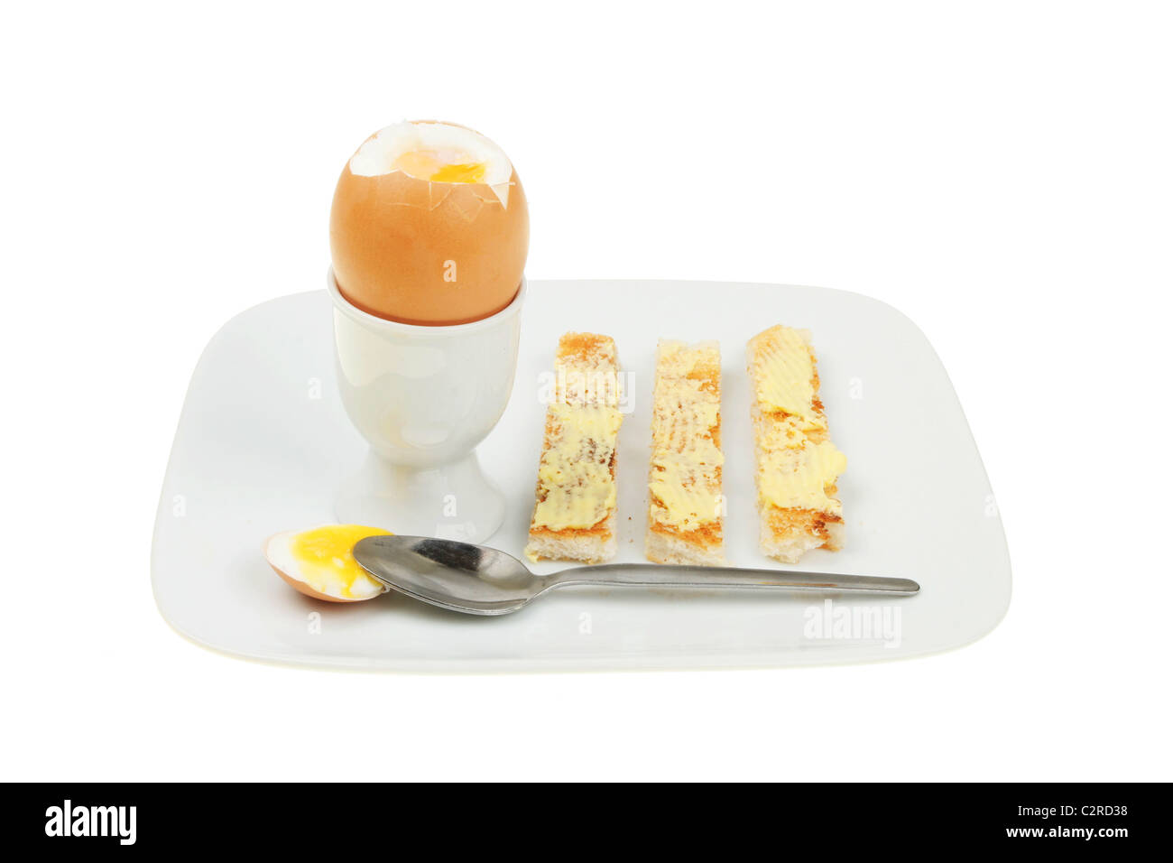 Weich gekochtes Ei und Toast mit Butter auf einem Teller Stockfoto