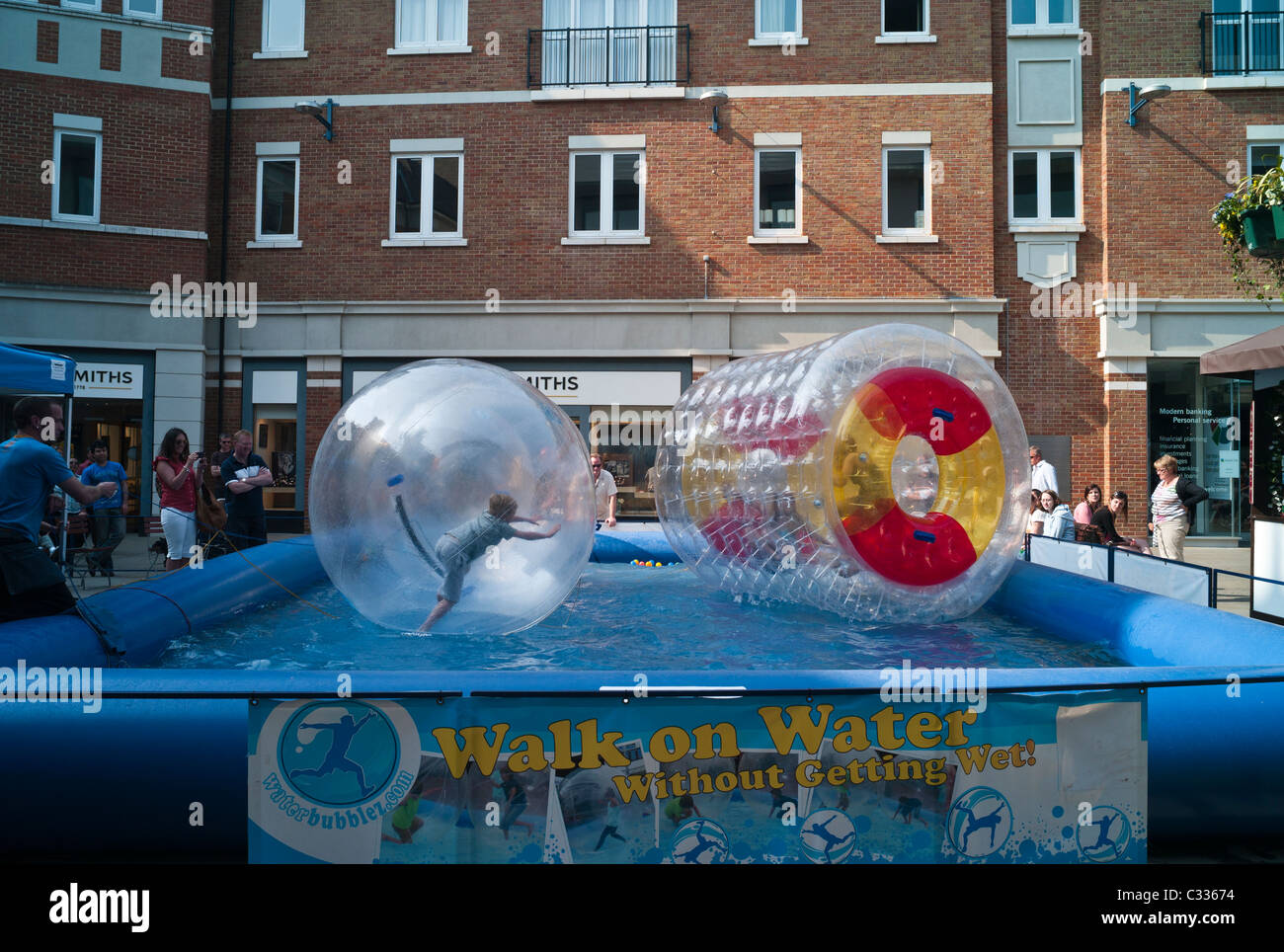 "Walk on Water ohne nass" aufblasbaren Bällen & Rad auf einen Pool mit Menschen spielen im Inneren. Stockfoto