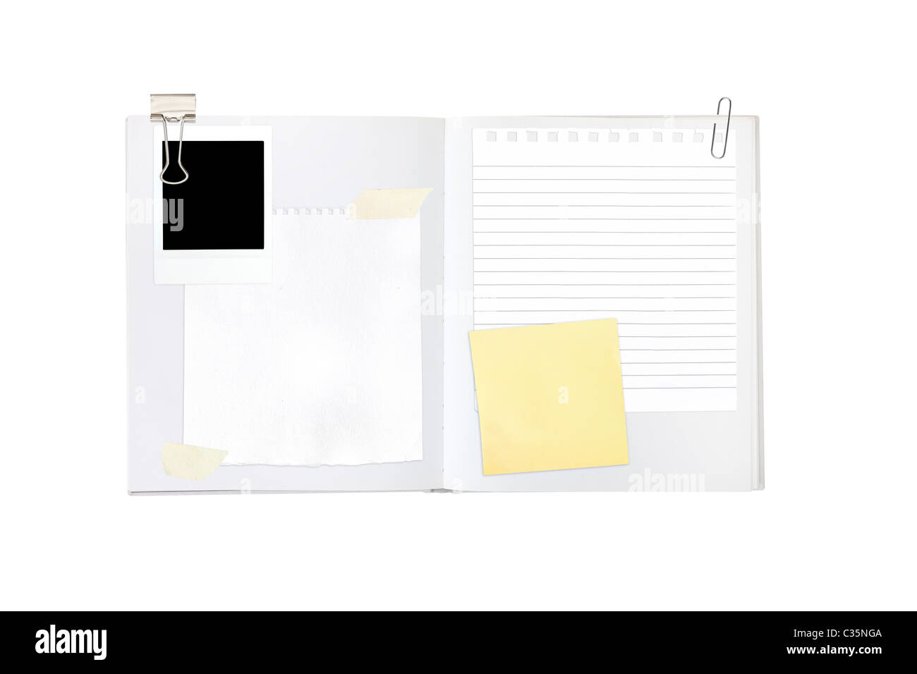 Scrapbook-Elemente inkl. Papiere und ein Foto auf ein leeres leeres Buch Stockfoto