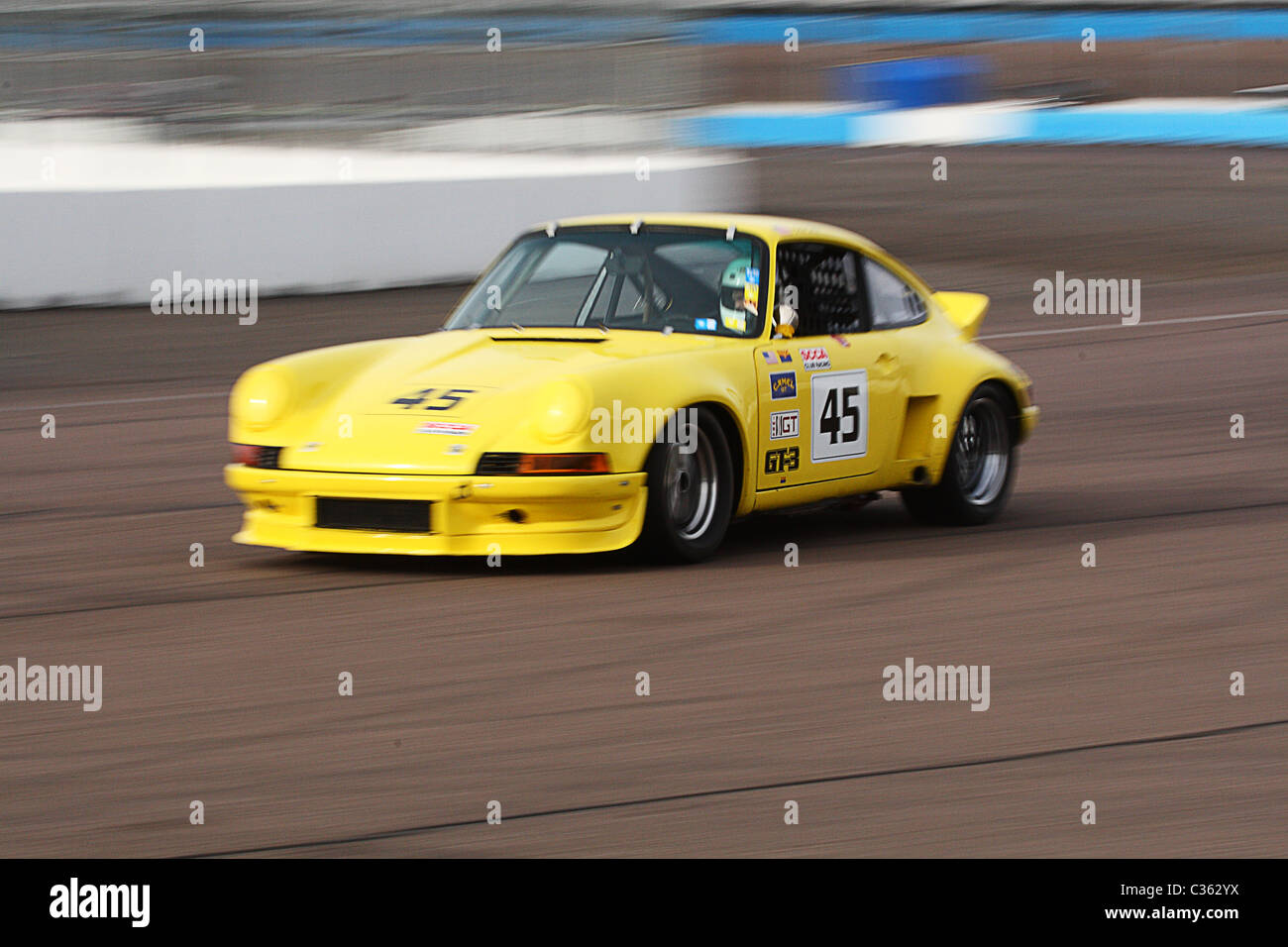 Panning Shot eine eine gelbe Oldtimer Porsche-Rennwagen Stockfoto