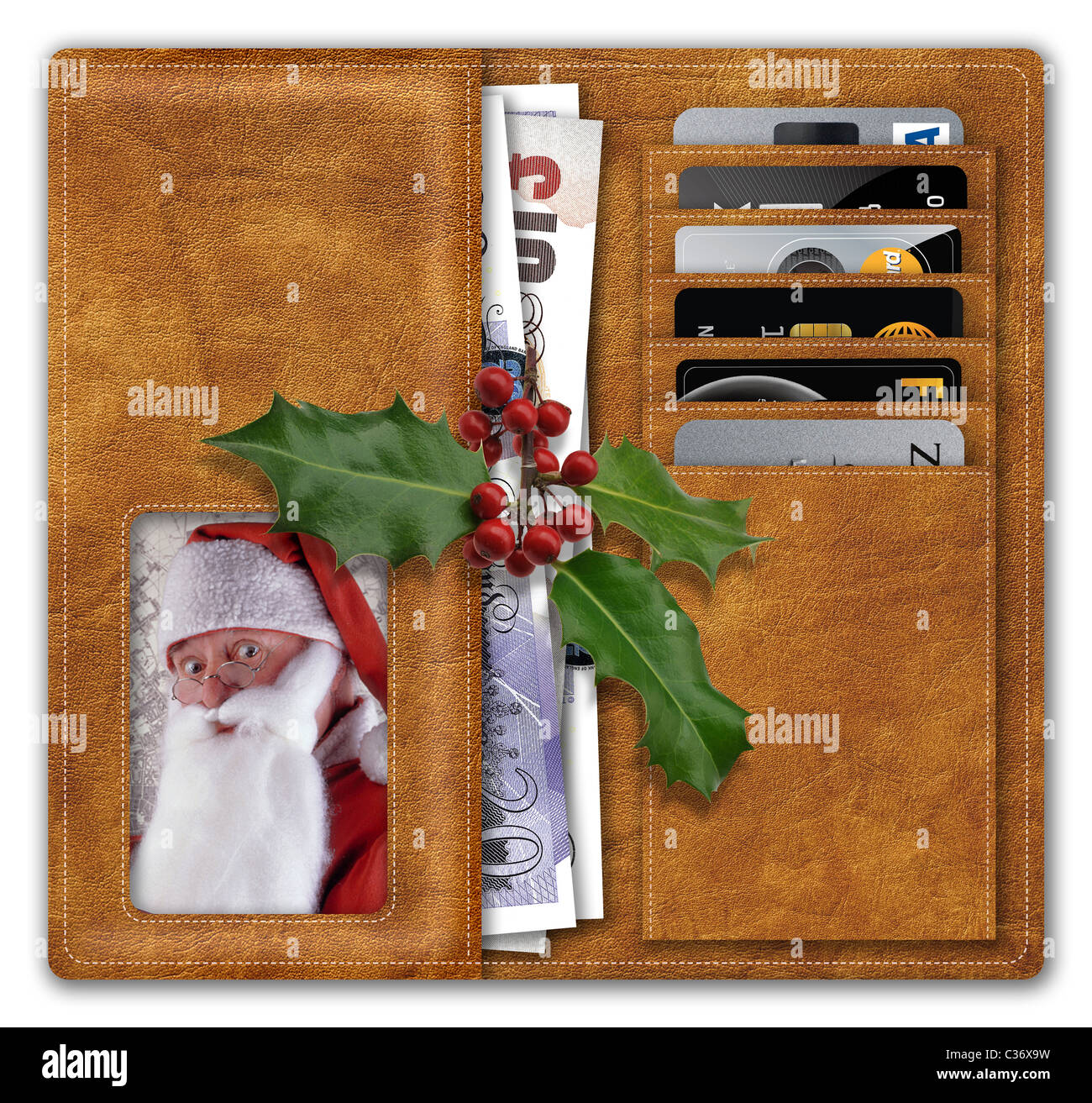 Geldbörse mit Pfund Sterling und Kreditkarten mit dem Weihnachtsmann im Fenster "Bild" und Weihnachten Holly an der Spitze. Stockfoto