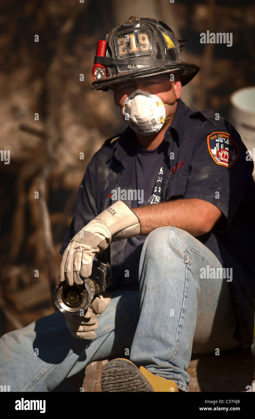 010915-N-3995K-021-New York, N.Y. (15. September 2001)--ruht ein New Yorker Feuerwehrmann auf den Trümmern, die einst die Welt Stockfoto