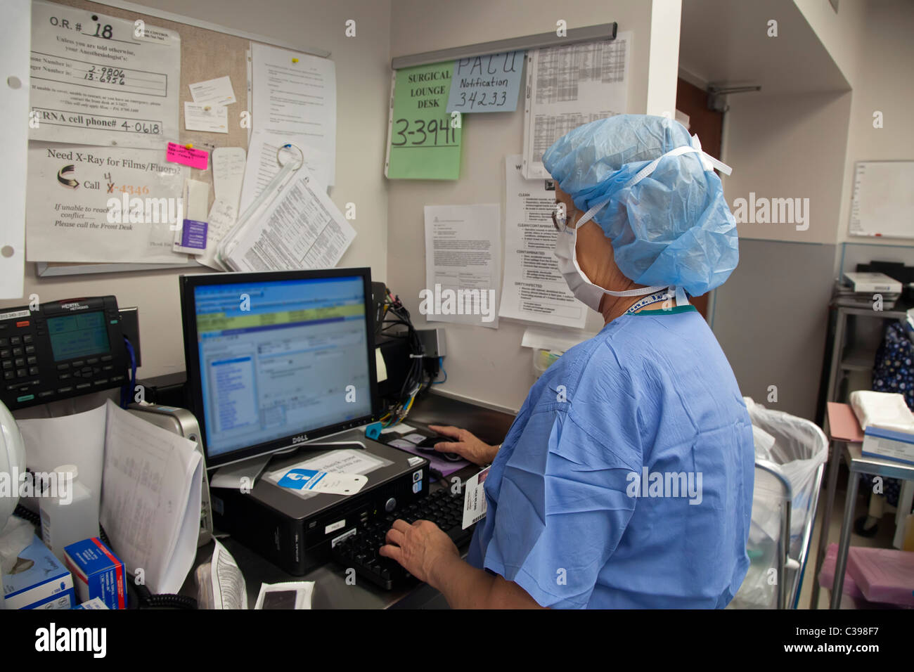 Krankenschwester gibt Daten im Computer im Krankenhaus-OP-Saal Stockfoto