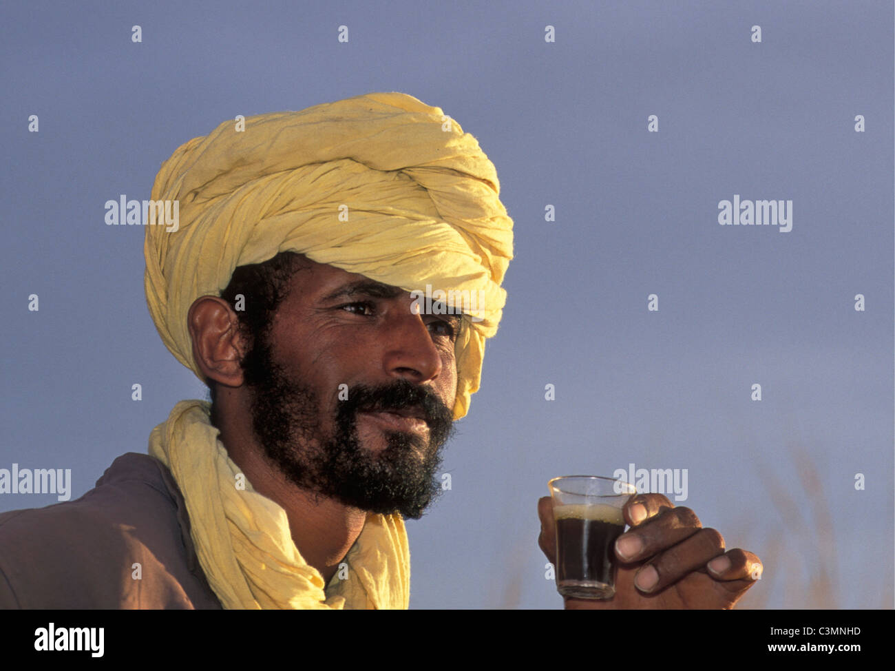 Algerien, in der Nähe von Djanet. Wüste Sahara. Mann der Tuareg Stamm Tee zu trinken. Porträt. Stockfoto