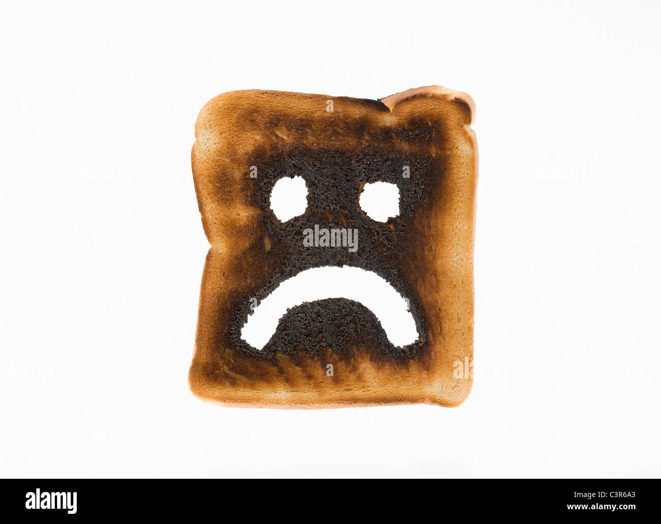 Verbranntem Toast mit traurigen Gesicht drauf Stockfoto