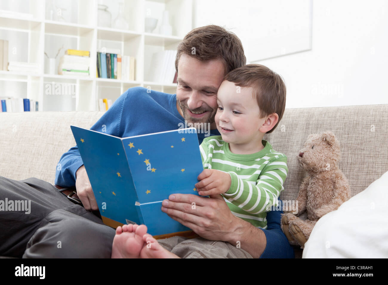 Deutschland, Bayern, München, Vater und junge (2-3 Jahre) liest ein Buch Stockfoto