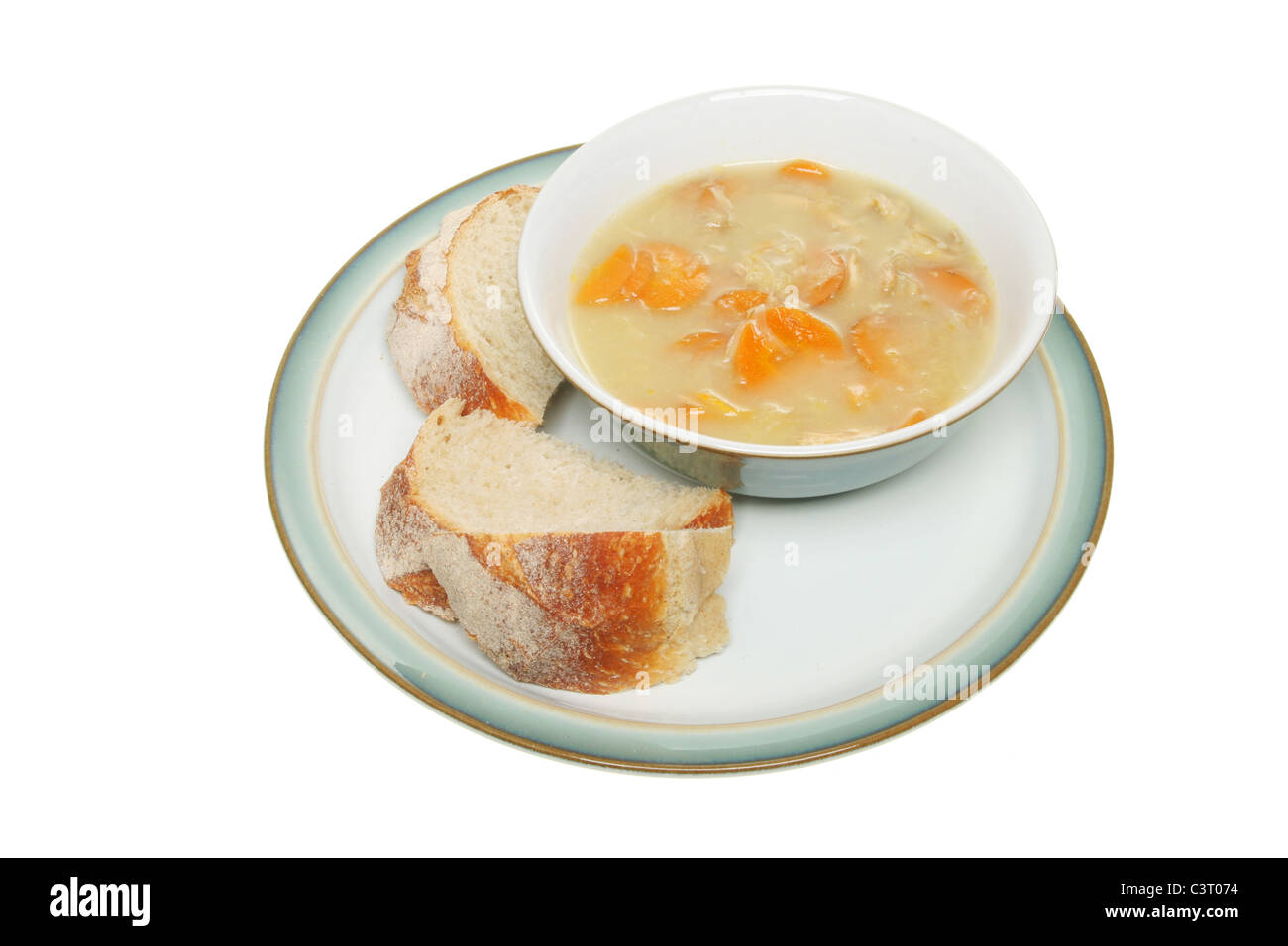 Schüssel mit Huhn und Gemüse Suppe mit Stücken von knusprigem Brot auf einem Teller Stockfoto