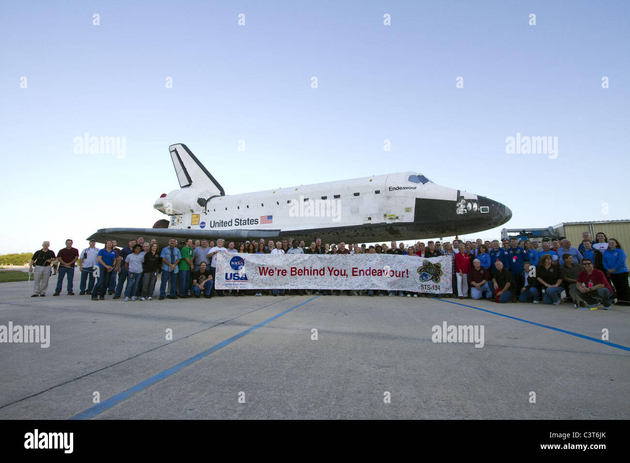 Wir hinter ihnen sind, versammeln, Endeavour Mitarbeiter um ein Banner zum Space Shuttle Endeavour STS-134 Mission, Gedenken an halten, wie es vom Orbiter Processing Facility-2 zum Vehicle Assembly Building verschoben wird. Bild-Gutschrift: NASA/Jack Pfaller 28. Februar 2011 Stockfoto