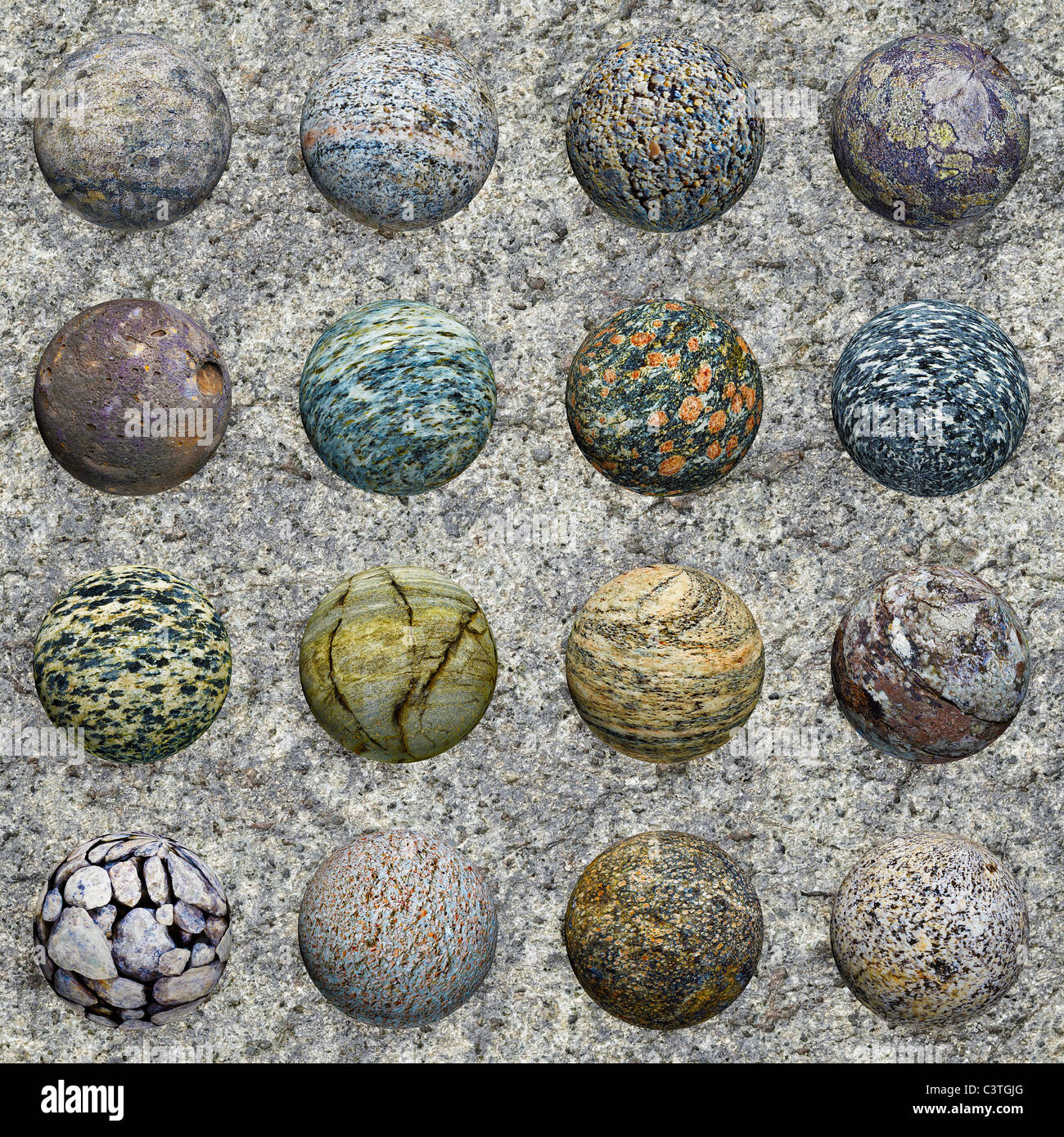Eine Reihe von Steinkugeln gegen eine Mauer aus Granit - nahtlose Textur Stockfoto