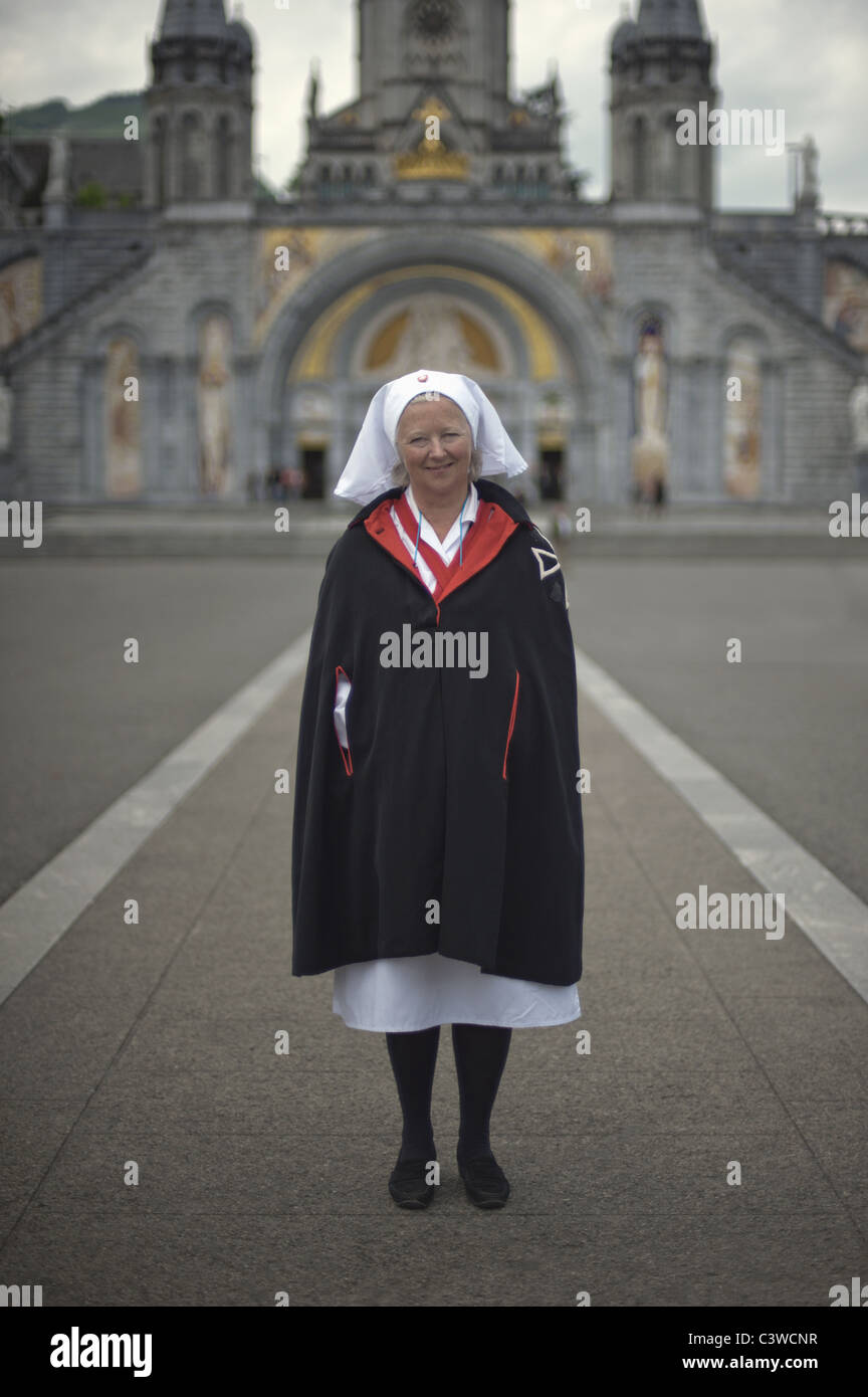 Ein Freiwilliger aus des Malteserordens steht vor der Basilika unserer lieben Frau vom Rosenkranz. Stockfoto