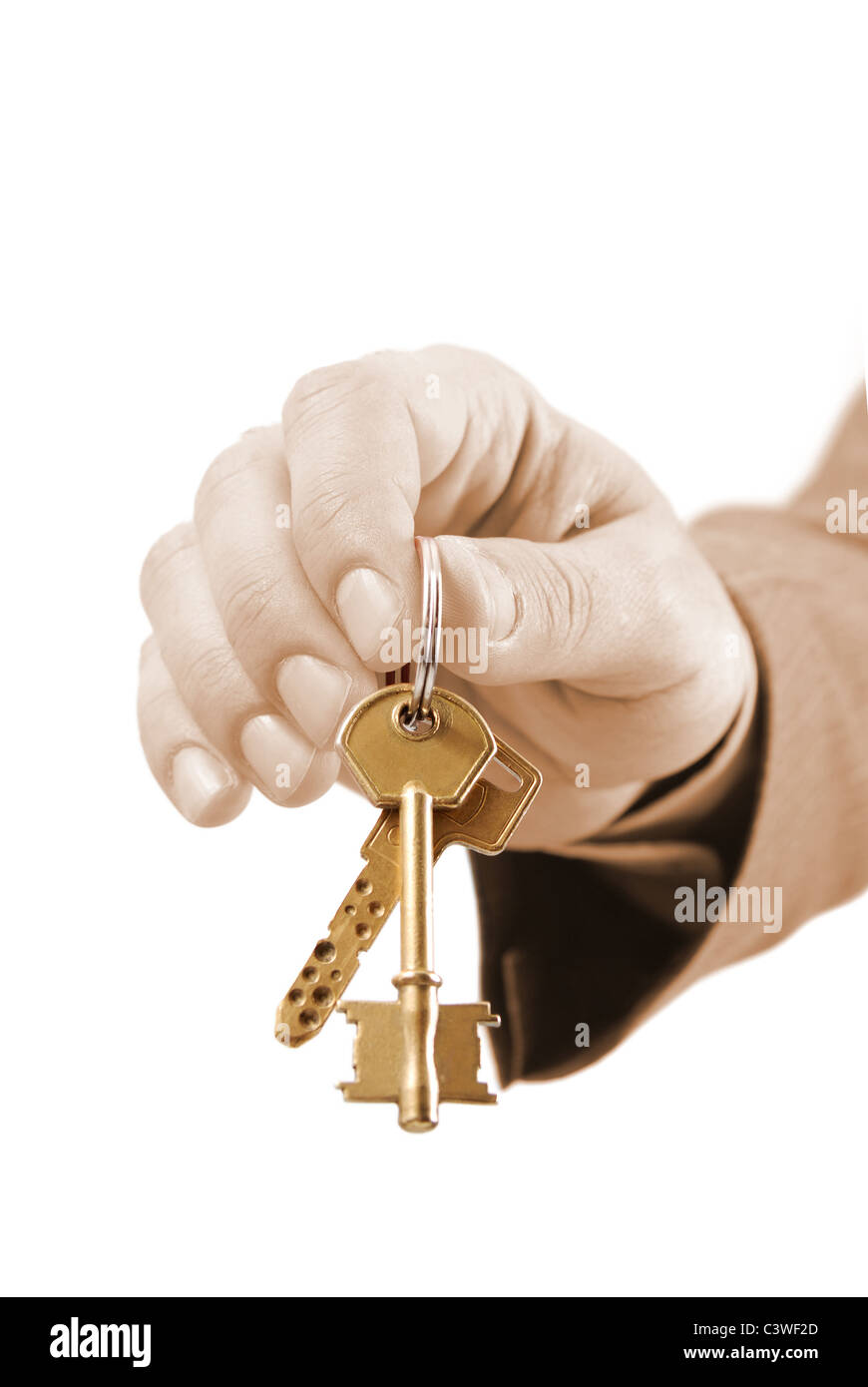 Nahaufnahme einer männlichen Real Estate Exekutive Hand mit zwei Tasten. Warme Farbtöne Bild. Stockfoto