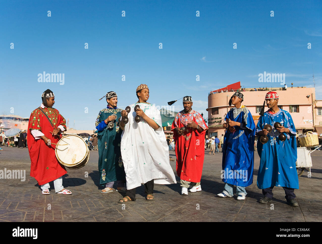 Musiker in traditioneller Kleidung unterhalten Touristen und Einheimische auf dem Marktplatz Djemaa el Fna. Marrakesch, Marokko. Stockfoto