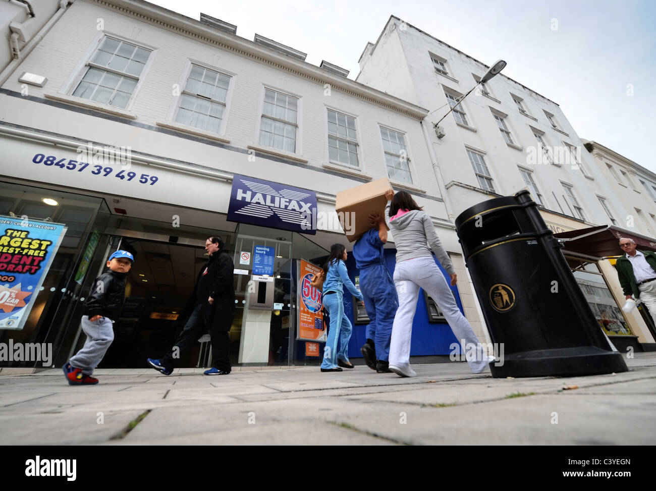 Shopper, vorbei an einem Zweig der Halifax Bank in Cheltenham UK Stockfoto