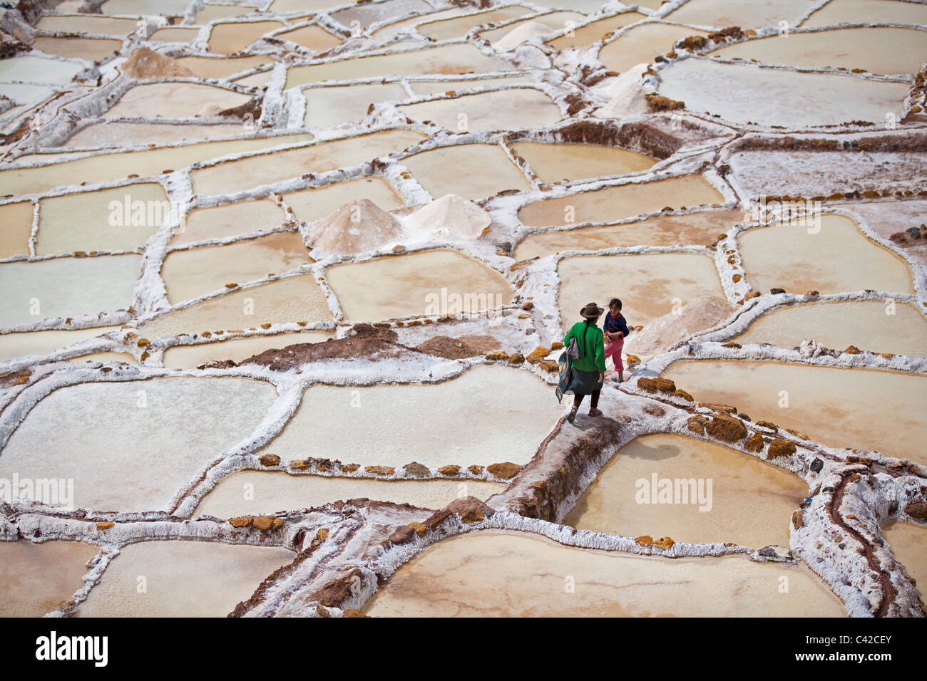 Peru, Maras, Salzgewinnung, Frau und Tochter in Salinen. Stockfoto