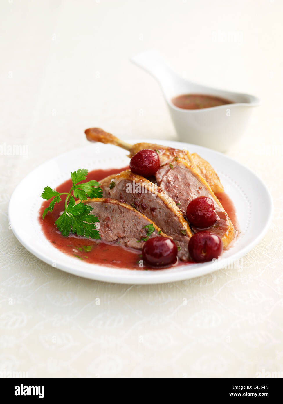 Fleischscheiben Ente mit Kirschen auf Platte (süß-sauer Gericht), Nahaufnahme Stockfoto