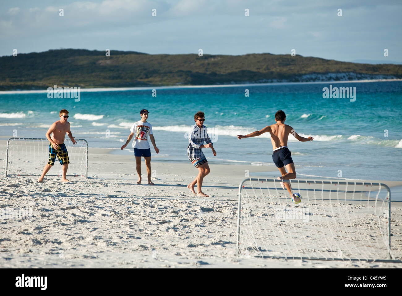 Junge Männer, Strandfußball zu spielen. Goode Beach, Franzose Bay, Albany, Western Australia, Australien Stockfoto