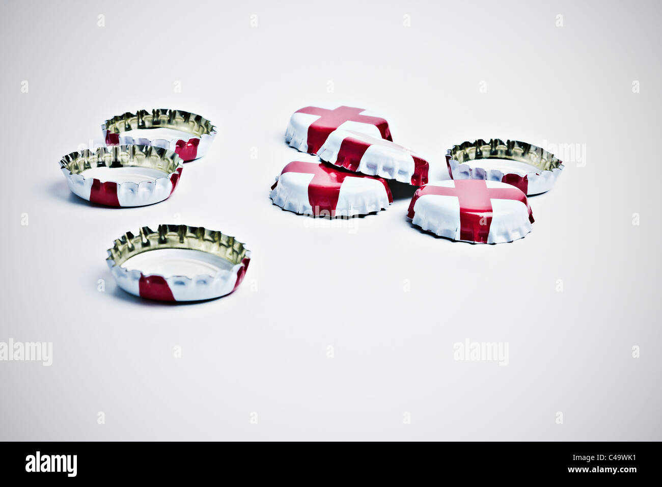 Acht Bier-Kronkorken mit St Georges Cross Emblem auf weißem Hintergrund Stockfoto