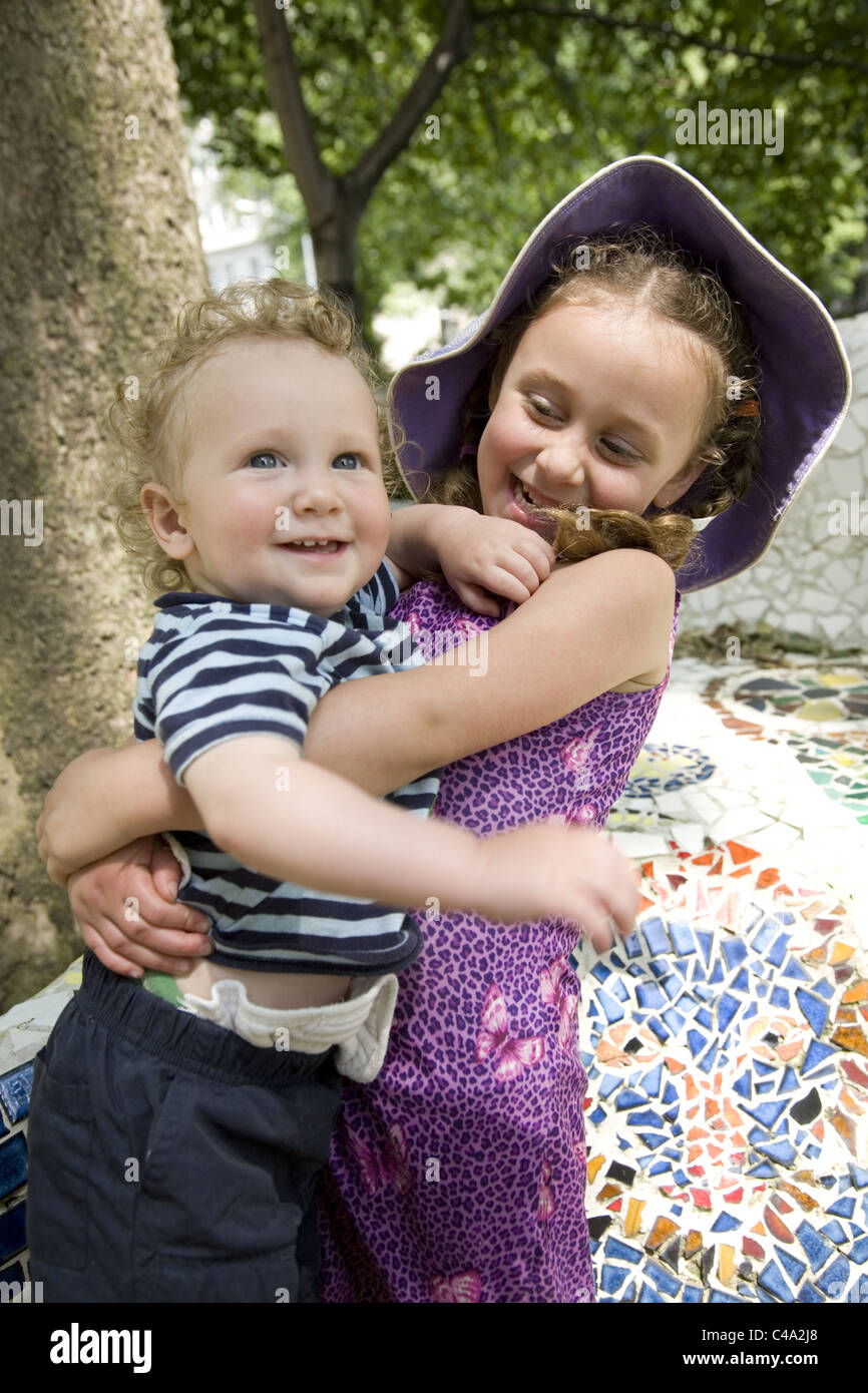 4 Jahre hält altes Mädchen sie 1 Jahre alten Bruder. Park, New York City. Stockfoto