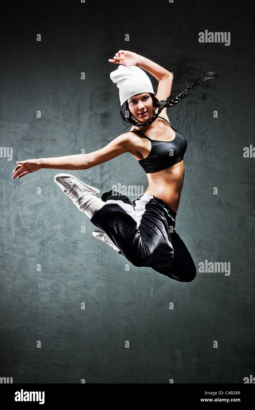 Junge Frau Tänzer springen. Auf Wand Hintergrund. Stockfoto