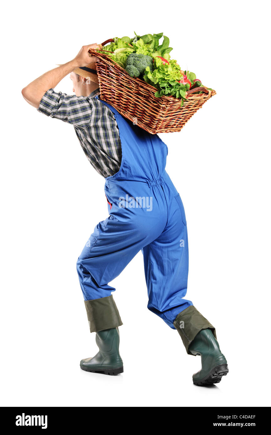 Voller Länge Porträt eines Bauern einen Korb mit Gemüse auf dem Rücken tragen Stockfoto