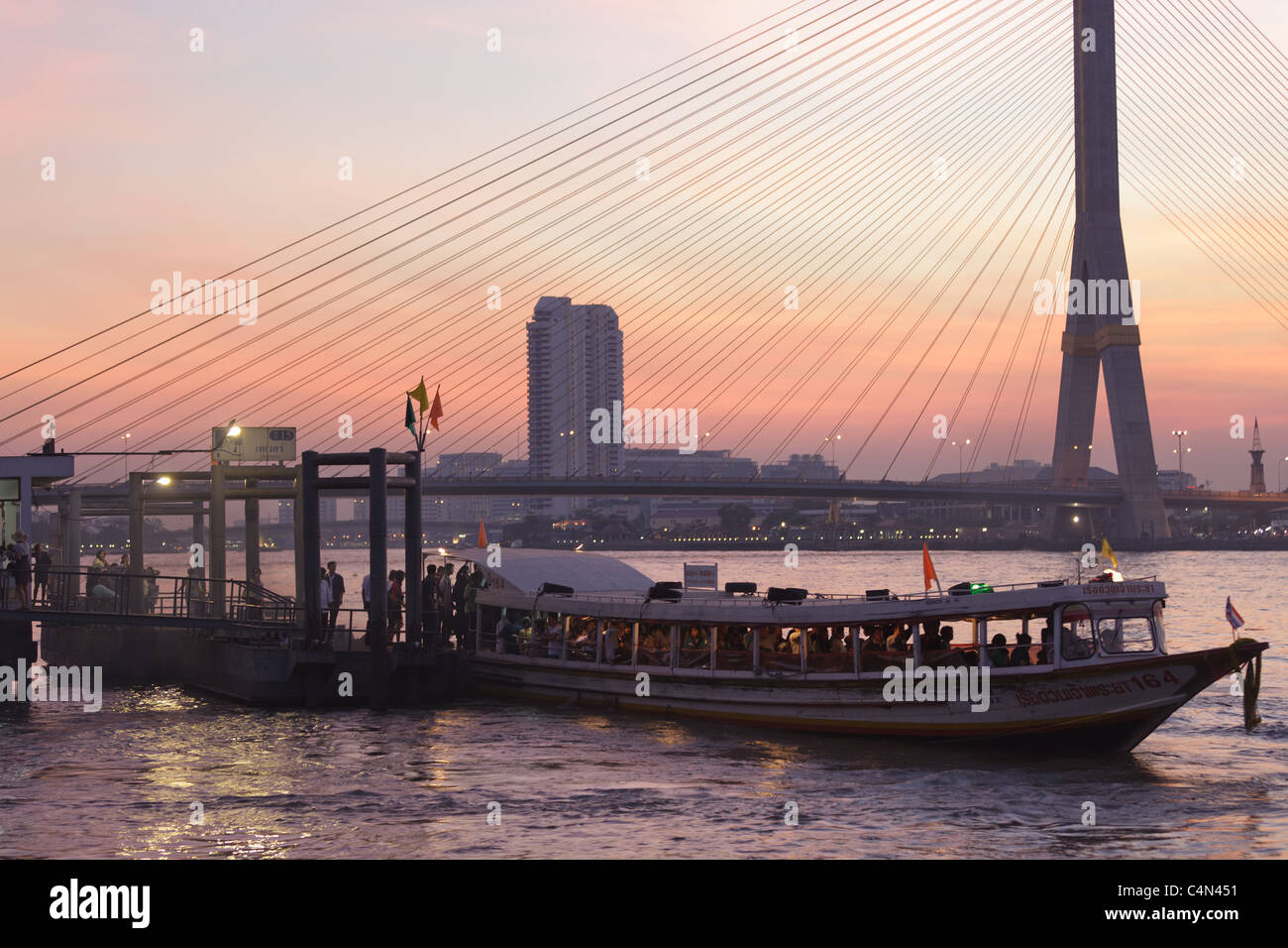 Bangkok, Thailand: Bürger Boottransport und Rama VIII Bridge in der Dämmerung, Blick vom Thewet Bezirk Stockfoto