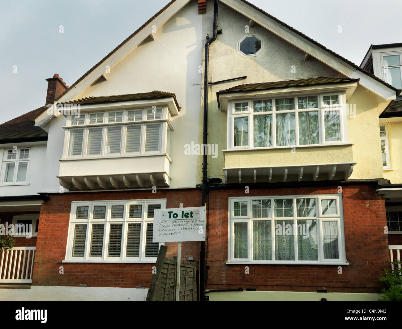 Doppelhaushälfte Haus umgewandelt in Wohnungen lassen eine Seite renoviert wurde, der andere hat nicht in England Stockfoto