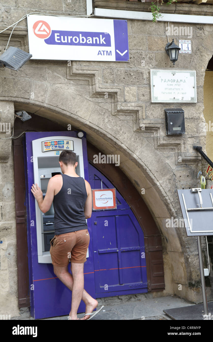 Griechisch am ATM Geld trotz der griechischen Wirtschaftskrise einlösen. Stockfoto