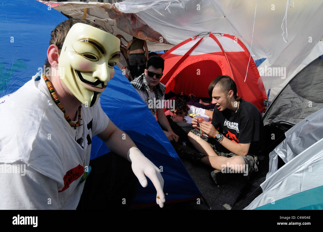 Ein spanischer Demonstrant mit einer anonymen Maske verbindet "wütenden" besetzen Puerta del Sol in Madrid. Stockfoto