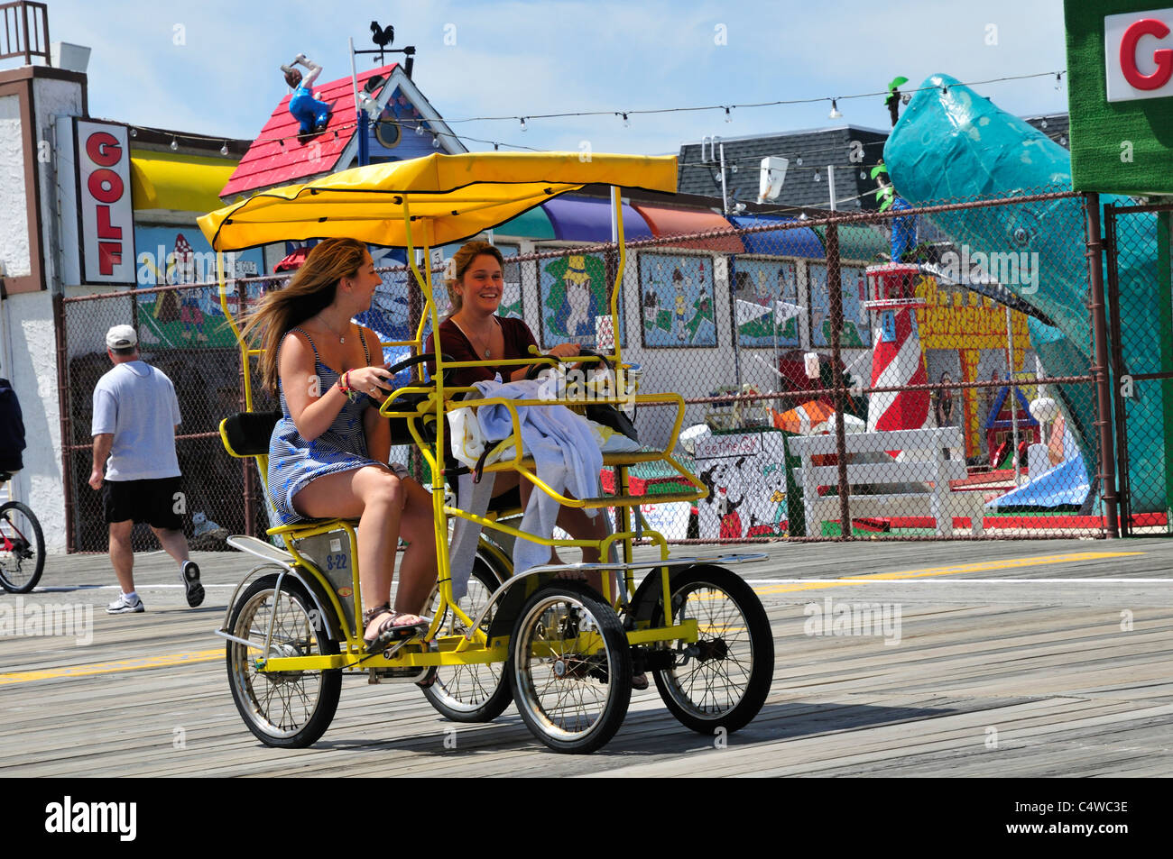 Zwei Mädchen teilen einen lachen beim Radeln die Surrey auf der Promenade in Ocean City, New Jersey Stockfoto