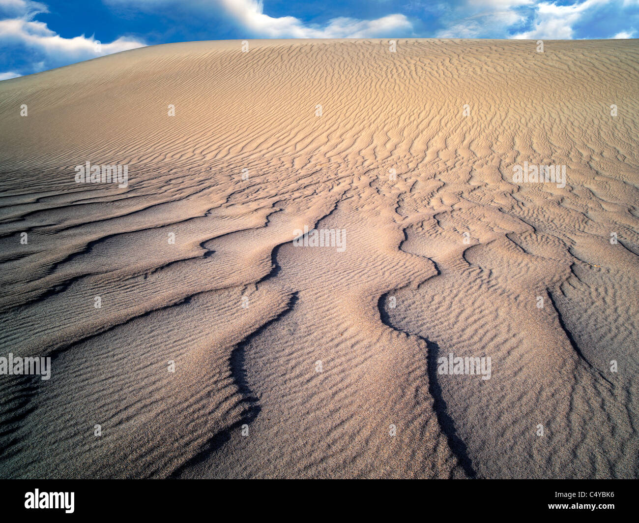 Wind kräuselt sich in Sanddünen. Death Valley Nationalpark, Kalifornien. Himmel wurde hinzugefügt Stockfoto