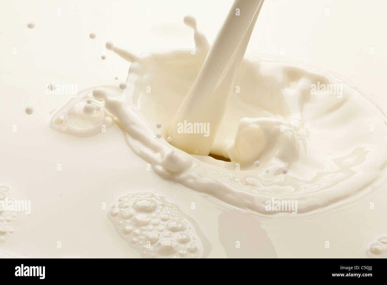 Spritzer Milch auf weißem Hintergrund Stockfoto