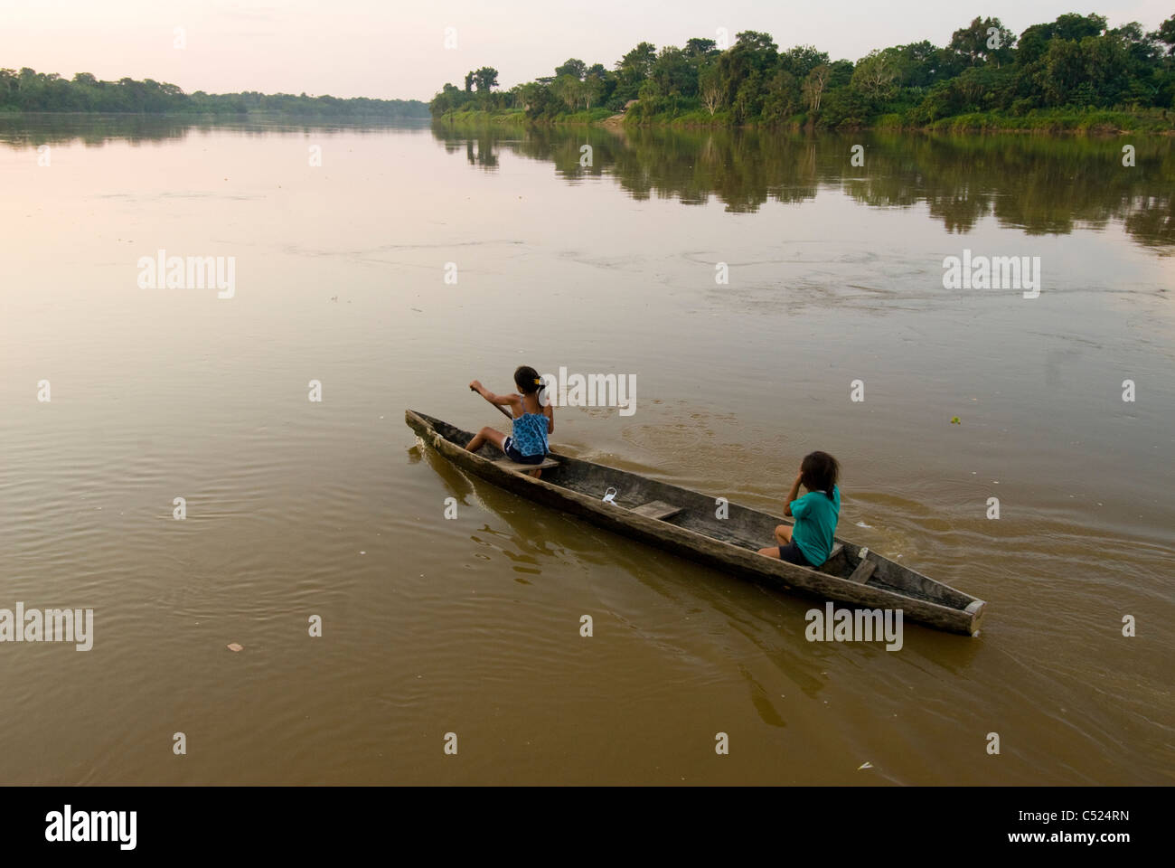 Junge Mädchen paddeln Einbaum auf Rio El Tigre (Amazonas-Nebenfluss), Loreto, Peru Stockfoto