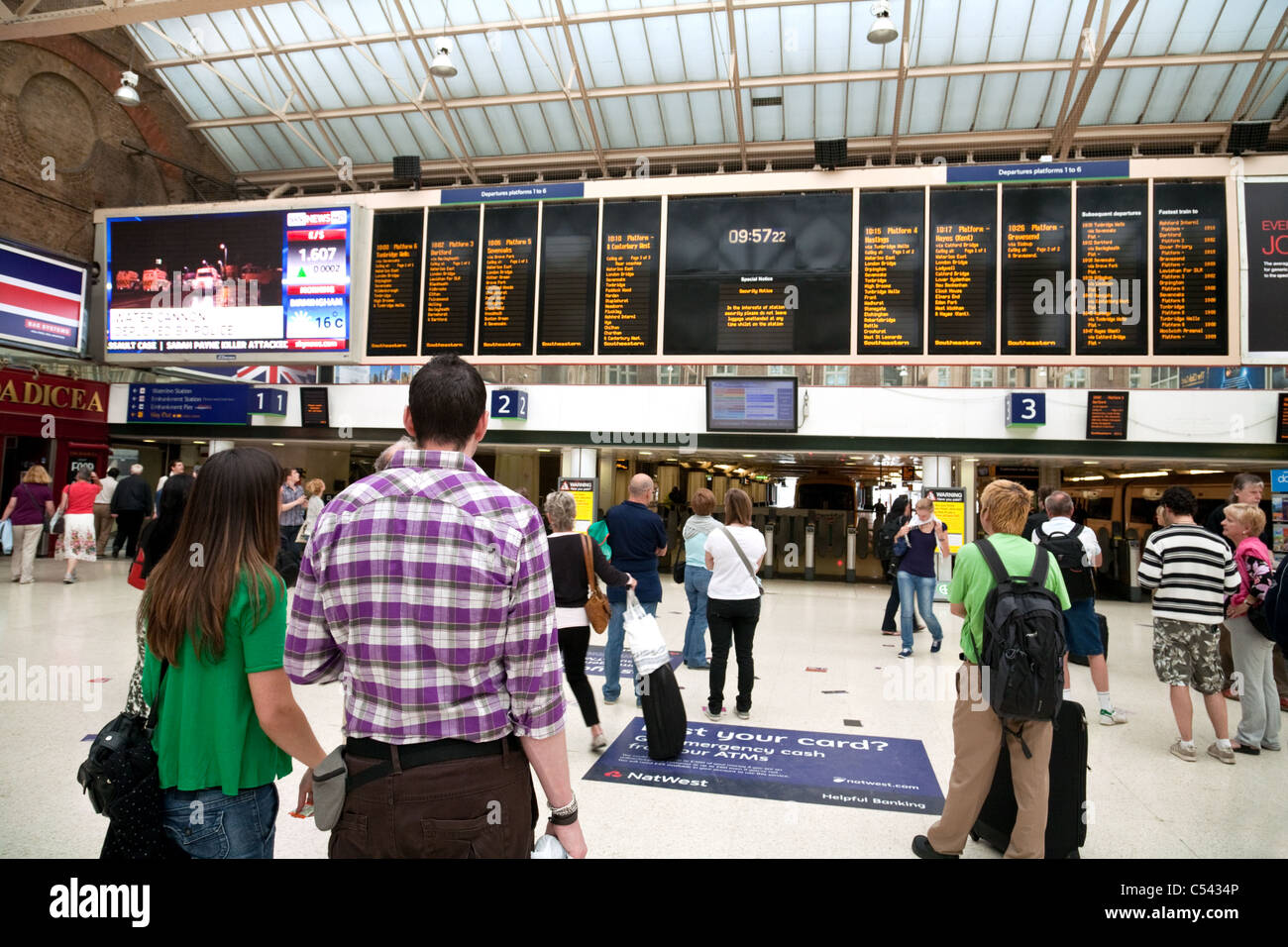 Passagiere warten auf einen Zug an der Londoner Charing Cross station Stockfoto