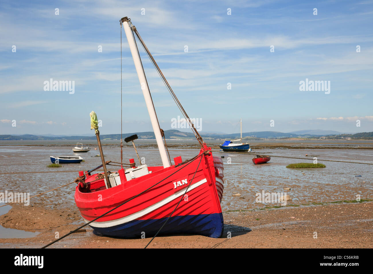 Morecambe Bay, Lancashire, England, UK. Gestrandeter rotes Boot am Morecambe Sandstrand bei Ebbe Stockfoto