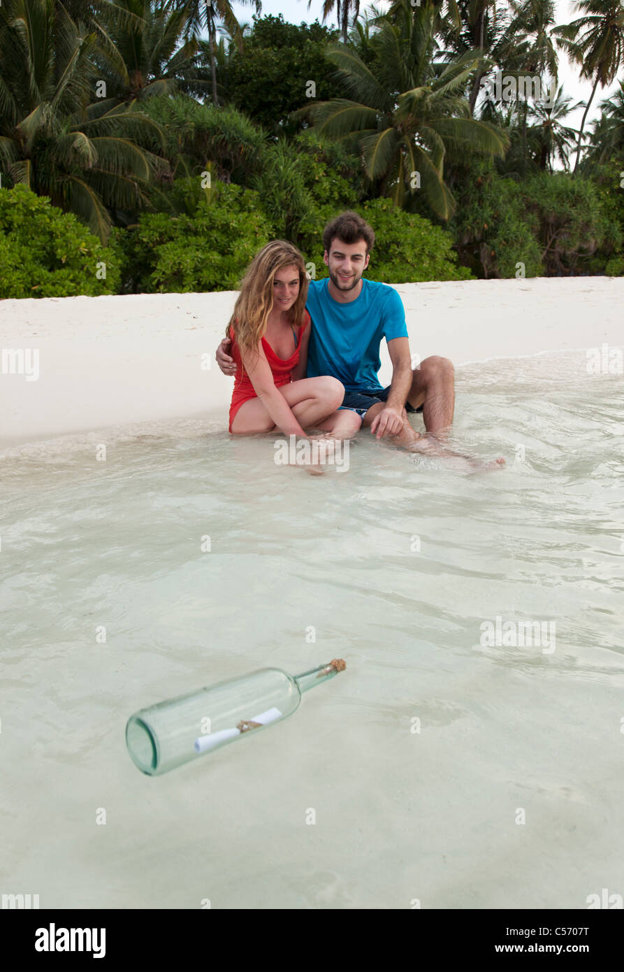 Paar am Strand eine Flaschenpost Stockfoto