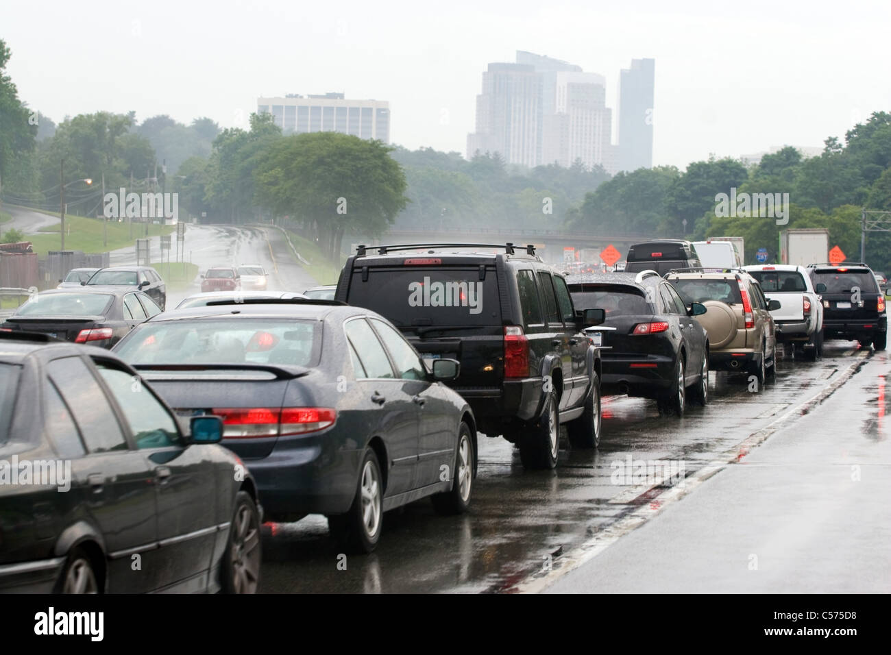 Eine viel befahrenen überlasteten Autobahn während der Hauptverkehrszeit etwas außerhalb der Stadt. Ungeduldig warten Fahrer im Straßenverkehr bei dem schlechten Wetter. Stockfoto