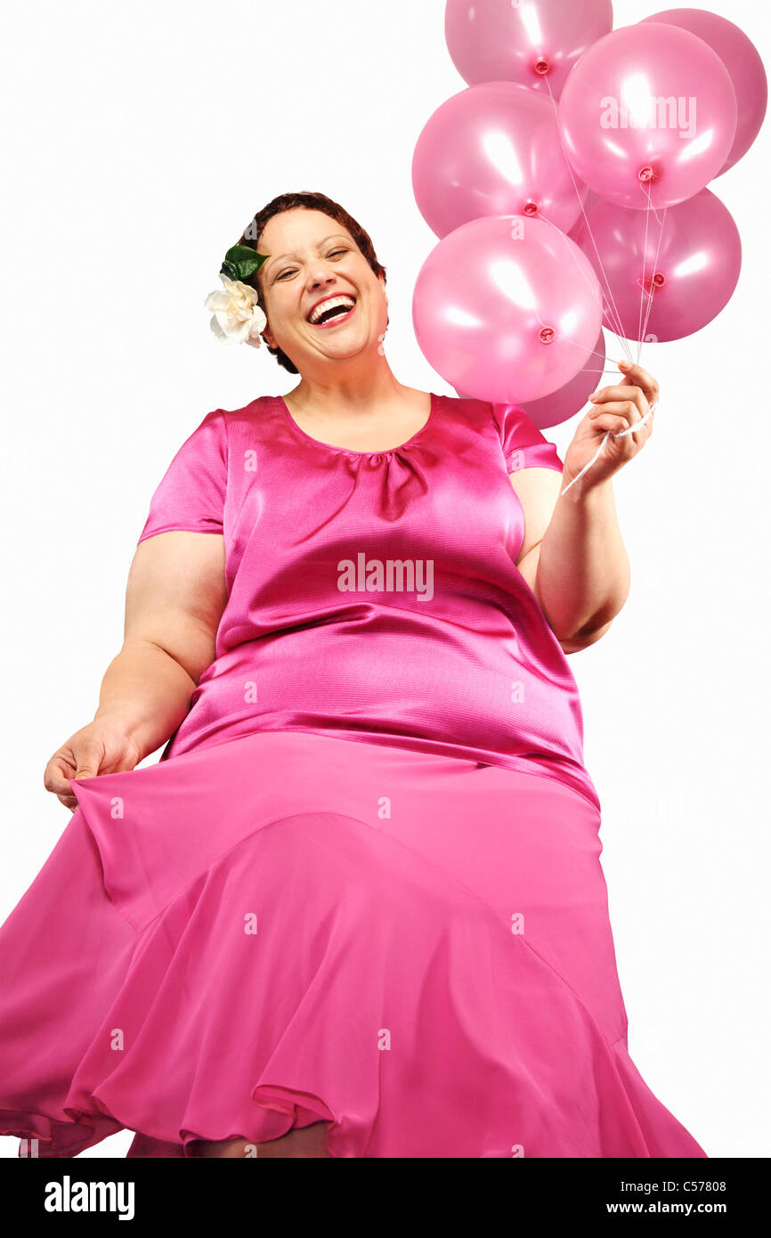 Große Frau mit Haufen Luftballons Stockfoto