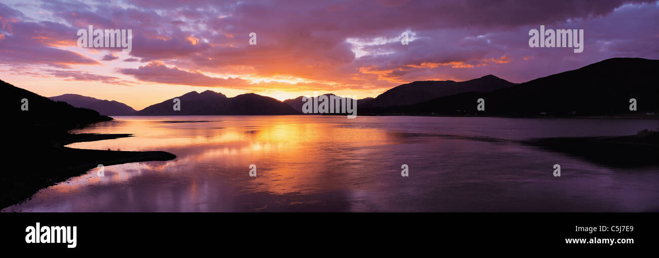 Lebendige Sonnenuntergang spiegelt sich in ruhigem Wasser, mit Hügelkette (Ardgour) Horizont, an der Kreuzung von Loch Linnhe und Loch Stockfoto