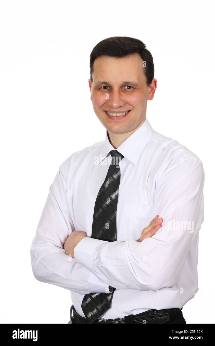 Angestellter in ein weißes Hemd und schwarze Krawatte, lächelnd schaut in die Kamera, weißer Hintergrund Stockfoto