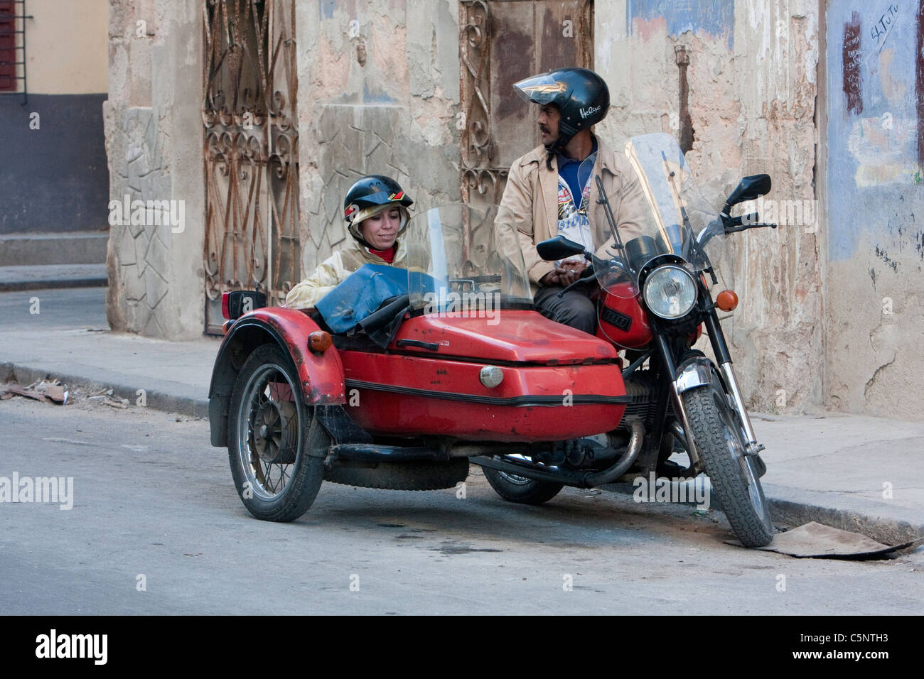 Kuba, Havanna. Paar, Reiten in Motorrad mit Beiwagen. Stockfoto