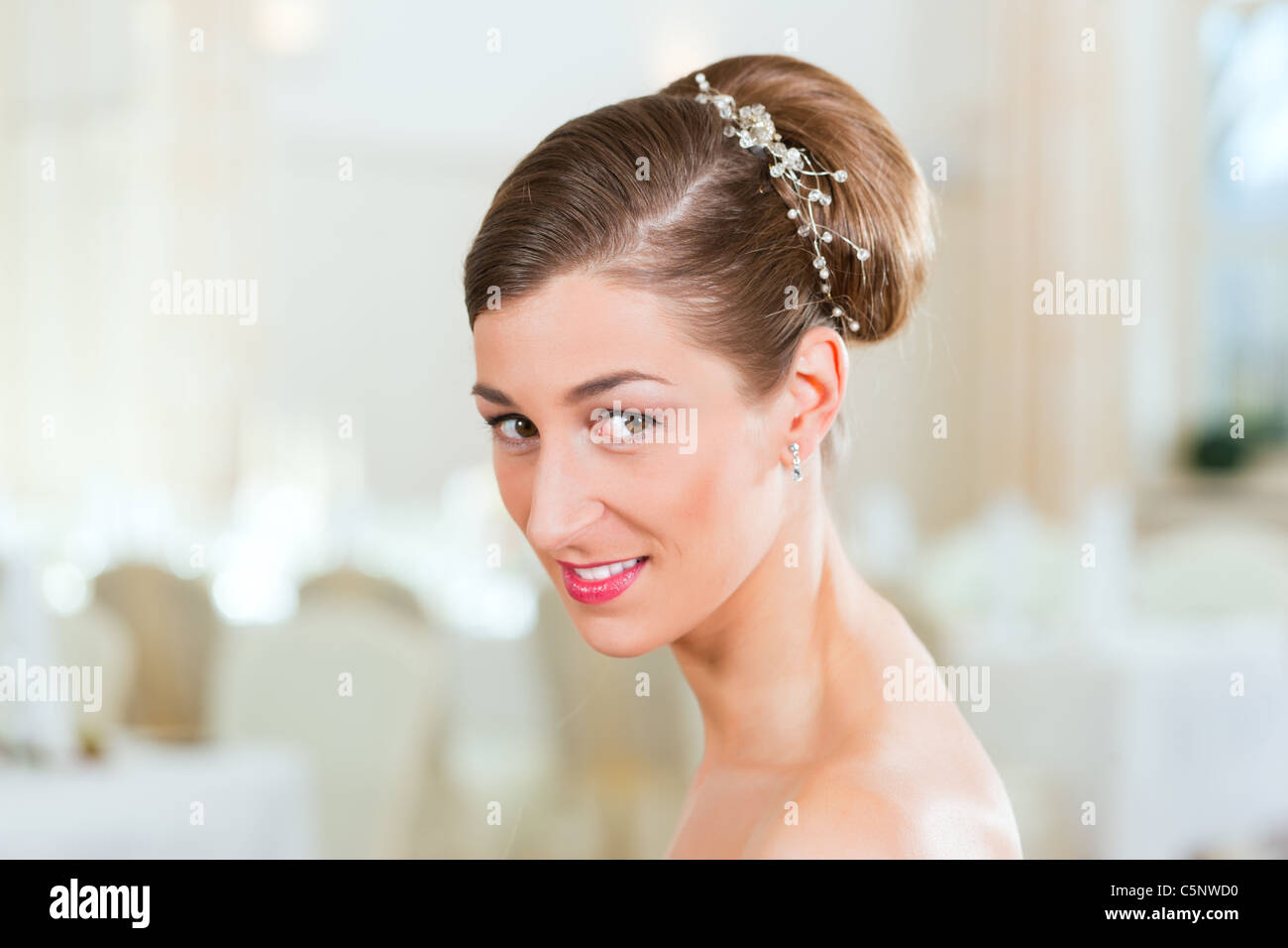 Lächelnde Braut mit gekämmtem Haar vor der Hochzeit Stockfoto