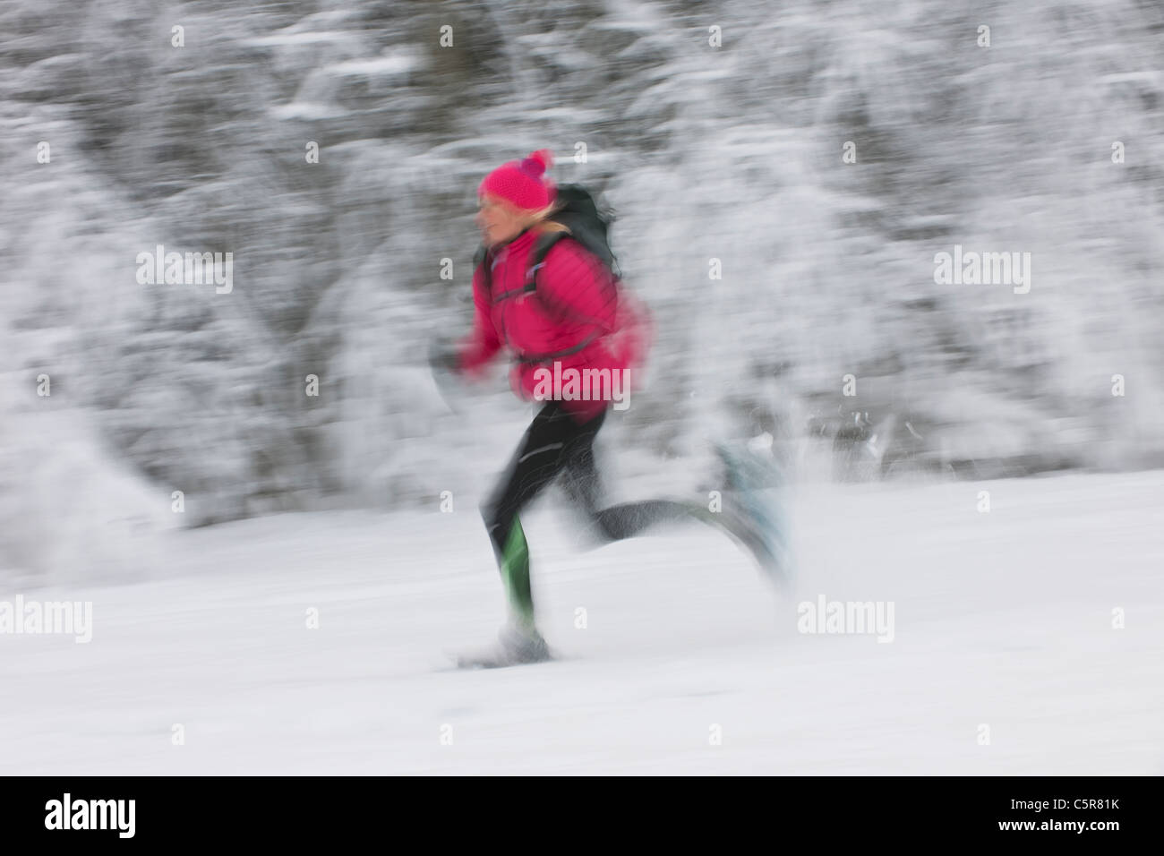 Ein Läufer mit Geschwindigkeit durch eine tief verschneite Landschaft bewegen. Stockfoto